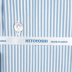 Close-up of the cuff showing button placement, stitching detail, and stripe continuation across the cuff.