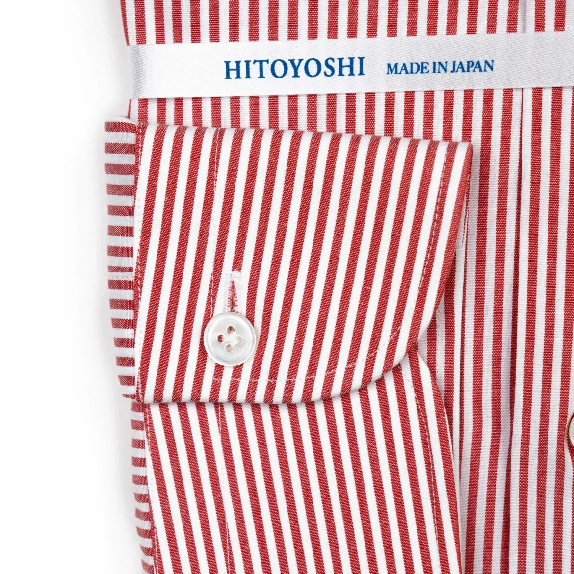 Close-up of the cuff showing stitching, button detail, and stripe continuation.