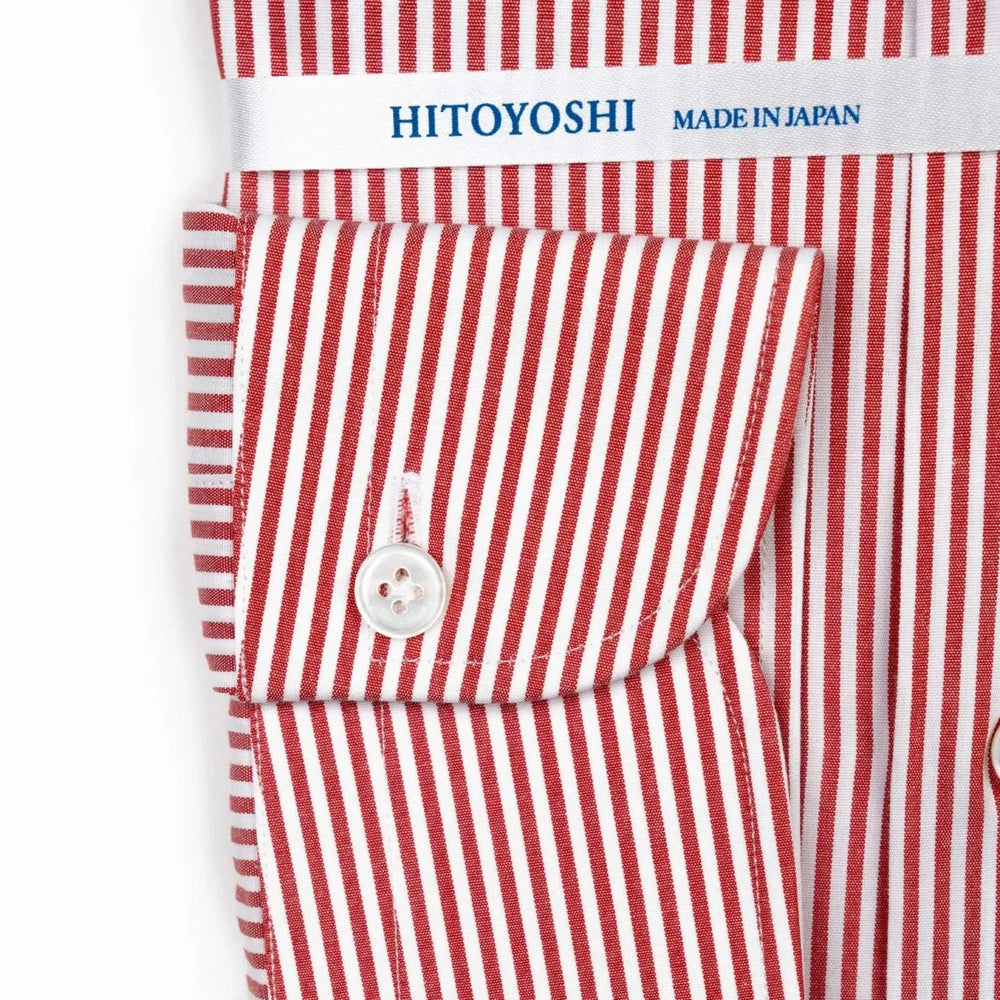 Close-up of the cuff showing stitching, button detail, and stripe continuation.