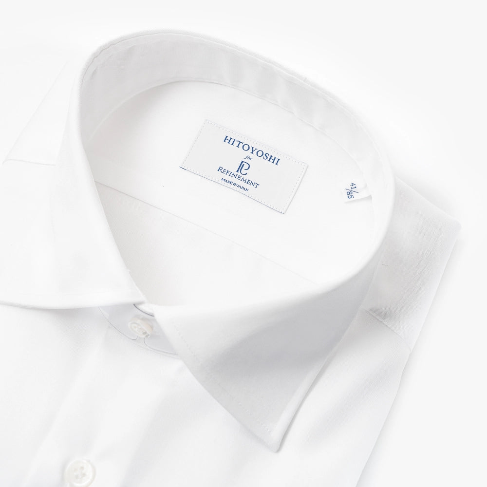 Close-up of the spread collar showing precise stitching, balanced collar shape, and smooth cotton weave.