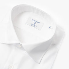 Close-up of the spread collar showing precise stitching, balanced collar shape, and smooth cotton weave.