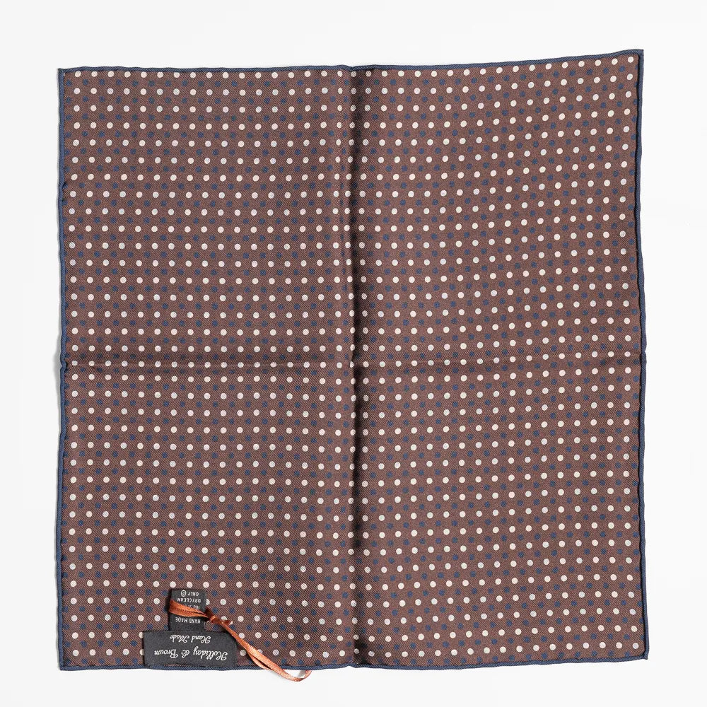 Close-up of the brown dot pattern highlighting silk texture and precise weaving detail.