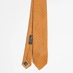 Full view of the Holliday & Brown small floral tie in orange, brown, and green showing delicate pattern and refined proportions.