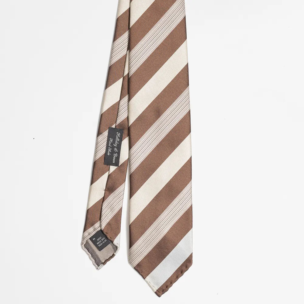 Full view of the Holliday & Brown stripe tie in brown and beige showing classic diagonal stripe pattern and refined proportions.
