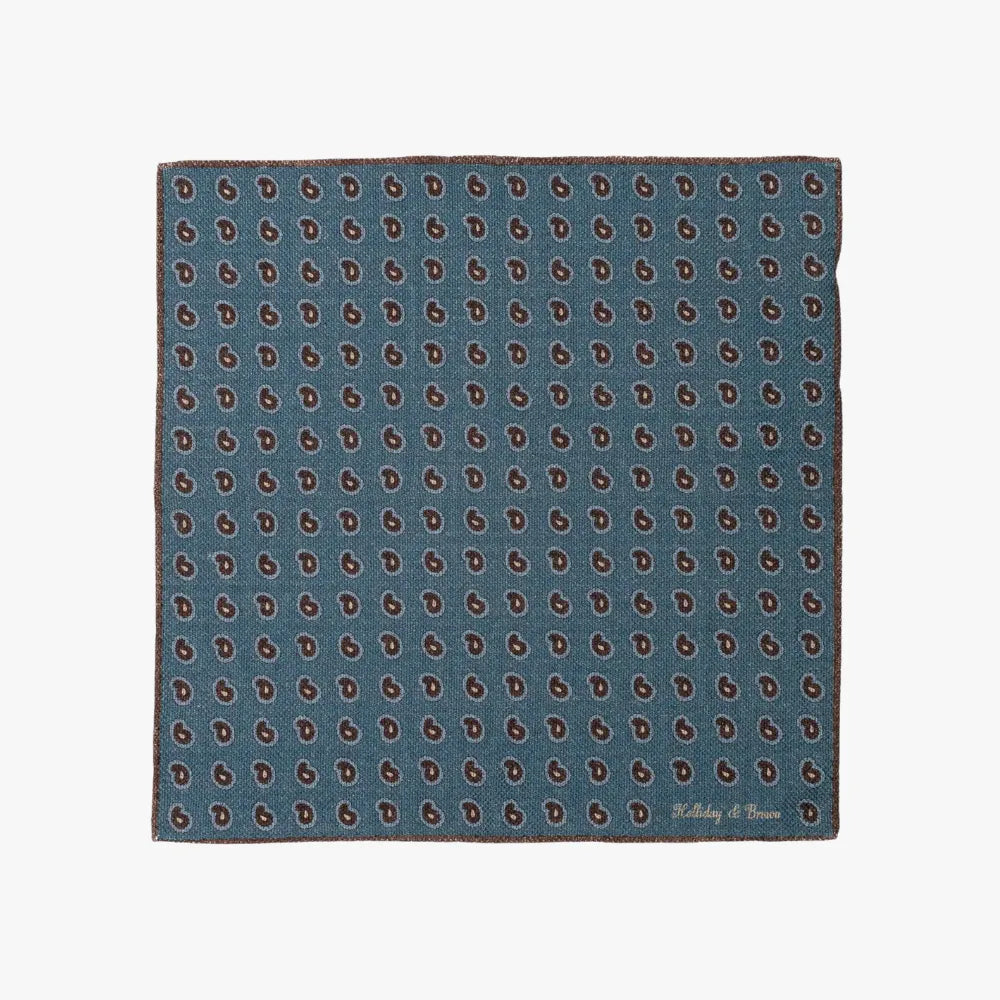 Full view of the Holliday & Brown pocket square in blue paisley, showing the full pattern layout, border design, and rich blue tones.