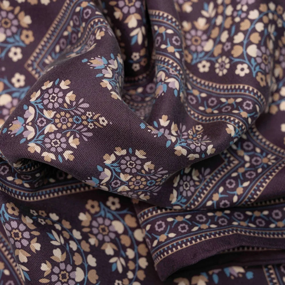 Close-up of the Holliday & Brown pocket square in plum showing the fine weave, drape, and intricate print work.