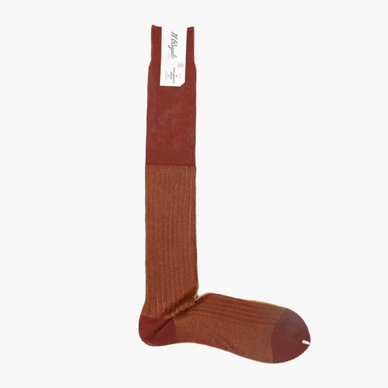 Full view of the Il Regalo Reversible Over The Calf Socks in Terracotta & Saffron showing the elongated silhouette, rib knit texture, and reversible color design.