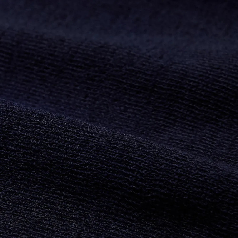 Close-up of the ice cotton knit fabric showing its cool-touch texture, tight weave, and deep navy coloration.