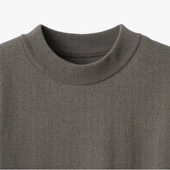 Close-up of the mock neck collar highlighting the structured ribbed knit and smooth finishing.