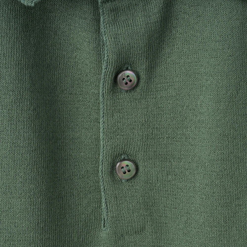 Close-up of the polo collar highlighting the structured knit collar and button placket detail.
