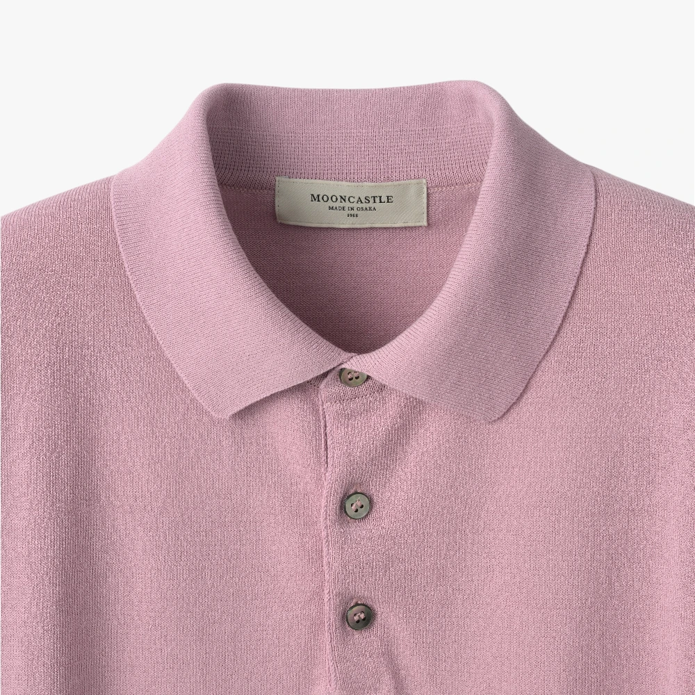 Close-up of the polo collar highlighting the structured knit collar and button placket detail.
