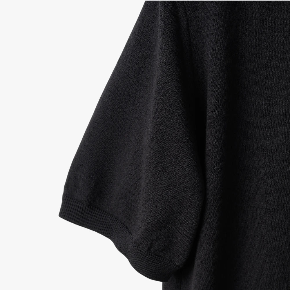 Close-up of the sleeve showing the knit texture and ribbed cuff detail.