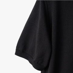 Close-up of the sleeve showing the knit texture and ribbed cuff detail.