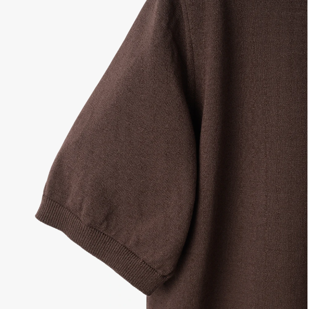 Close-up of the sleeve showing the knit texture and ribbed cuff detail.