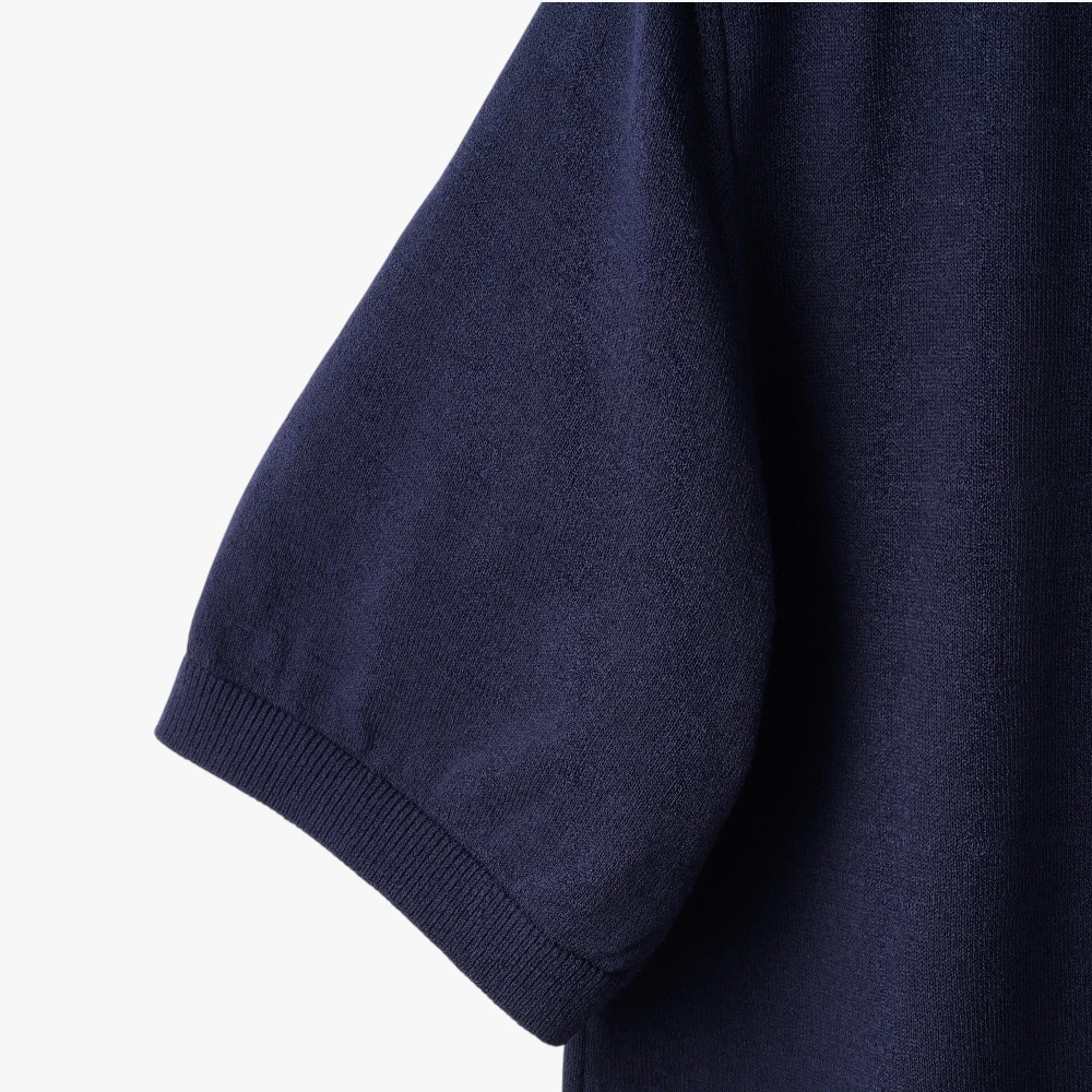 Close-up of the sleeve showing the knit texture and ribbed cuff detail.
