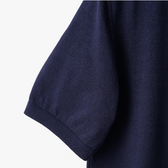Close-up of the sleeve showing the knit texture and ribbed cuff detail.
