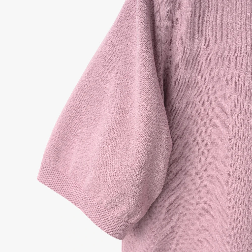 Close-up of the sleeve showing the knit texture and ribbed cuff detail.