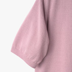 Close-up of the sleeve showing the knit texture and ribbed cuff detail.