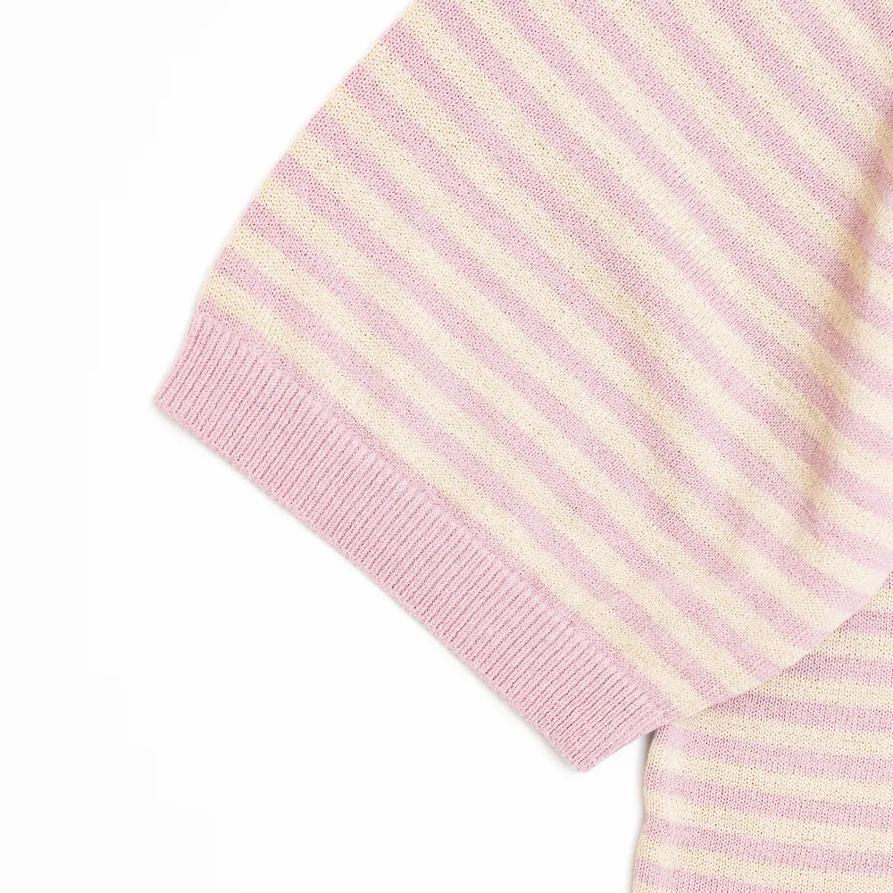 Close-up of the sleeve showing the knit texture and ribbed cuff finishing.

