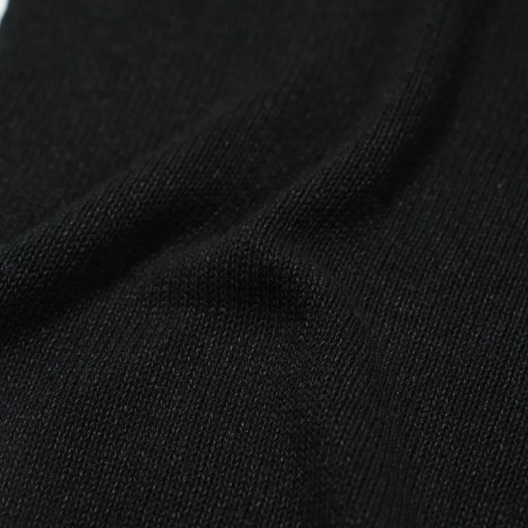 Close-up of the paper-silk blend fabric showing its ultra-light texture, soft handfeel, and matte black appearance.