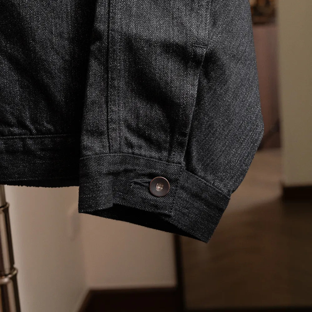 Close-up of the sleeve cuff with button fastening and refined finishing.
