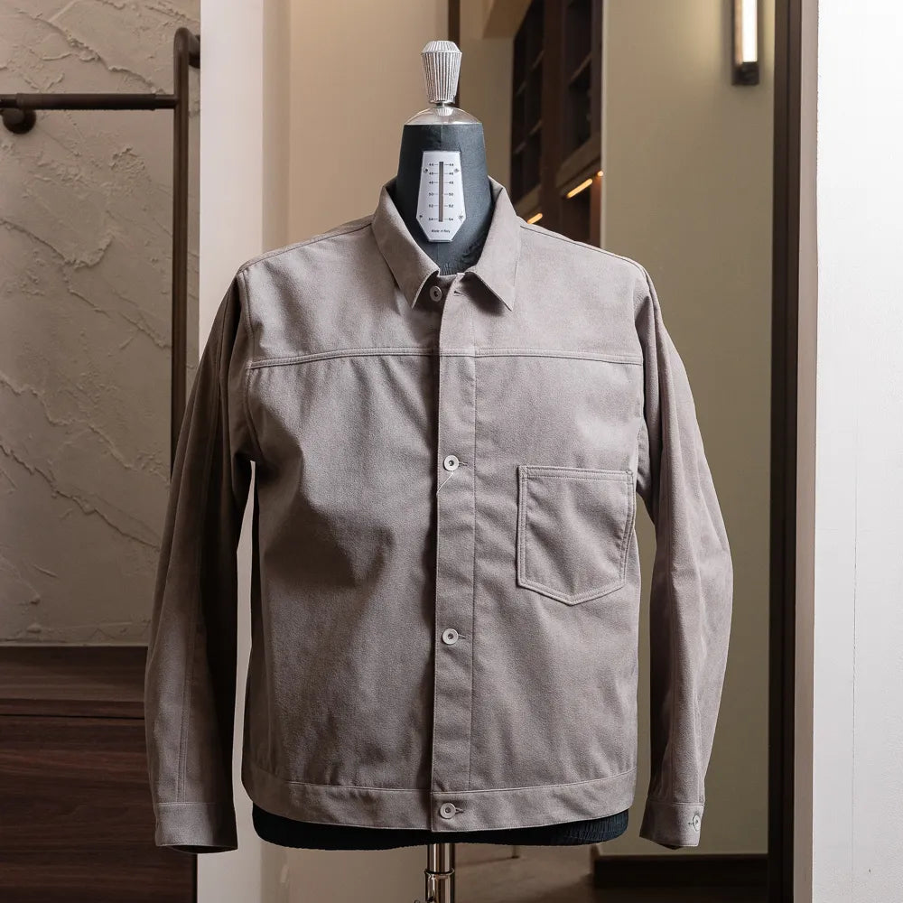 Front view of the Nanamica Synthetic Leather Short Jacket in gray featuring a clean cropped silhouette and structured design.