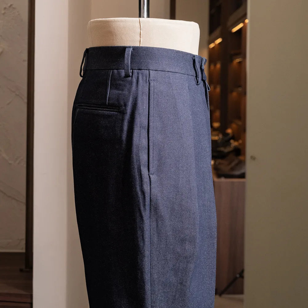 Side view of the indigo denim showing straight leg profile and tailored proportions.
