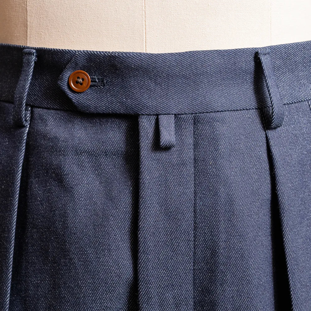Close-up of the waistband and belt loops highlighting structured finishing and stitching detail.
