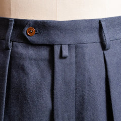 Close-up of the waistband and belt loops highlighting structured finishing and stitching detail.
