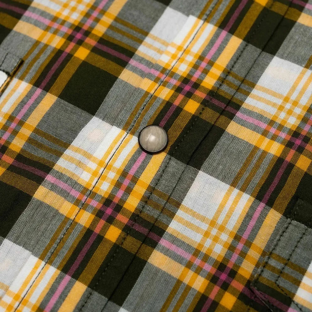 Close-up of the yellow checked Madras fabric showing handwoven texture, weave variation, and lightweight cotton feel.