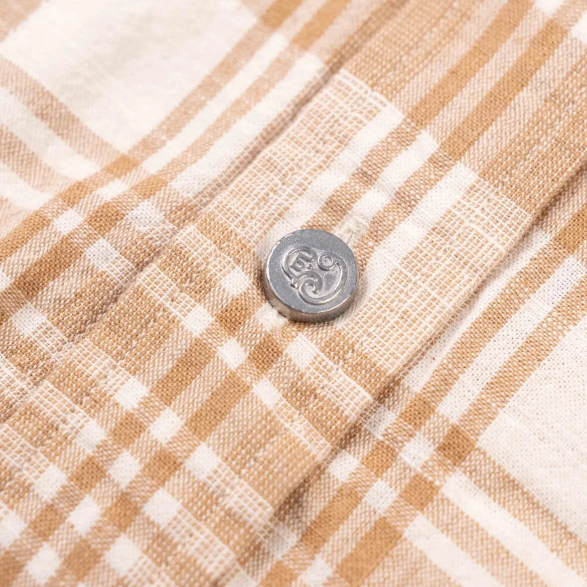 Close-up of the Madras fabric on the N5 Classic Shirt Beige showing the handwoven texture, color variation, and soft cotton feel.