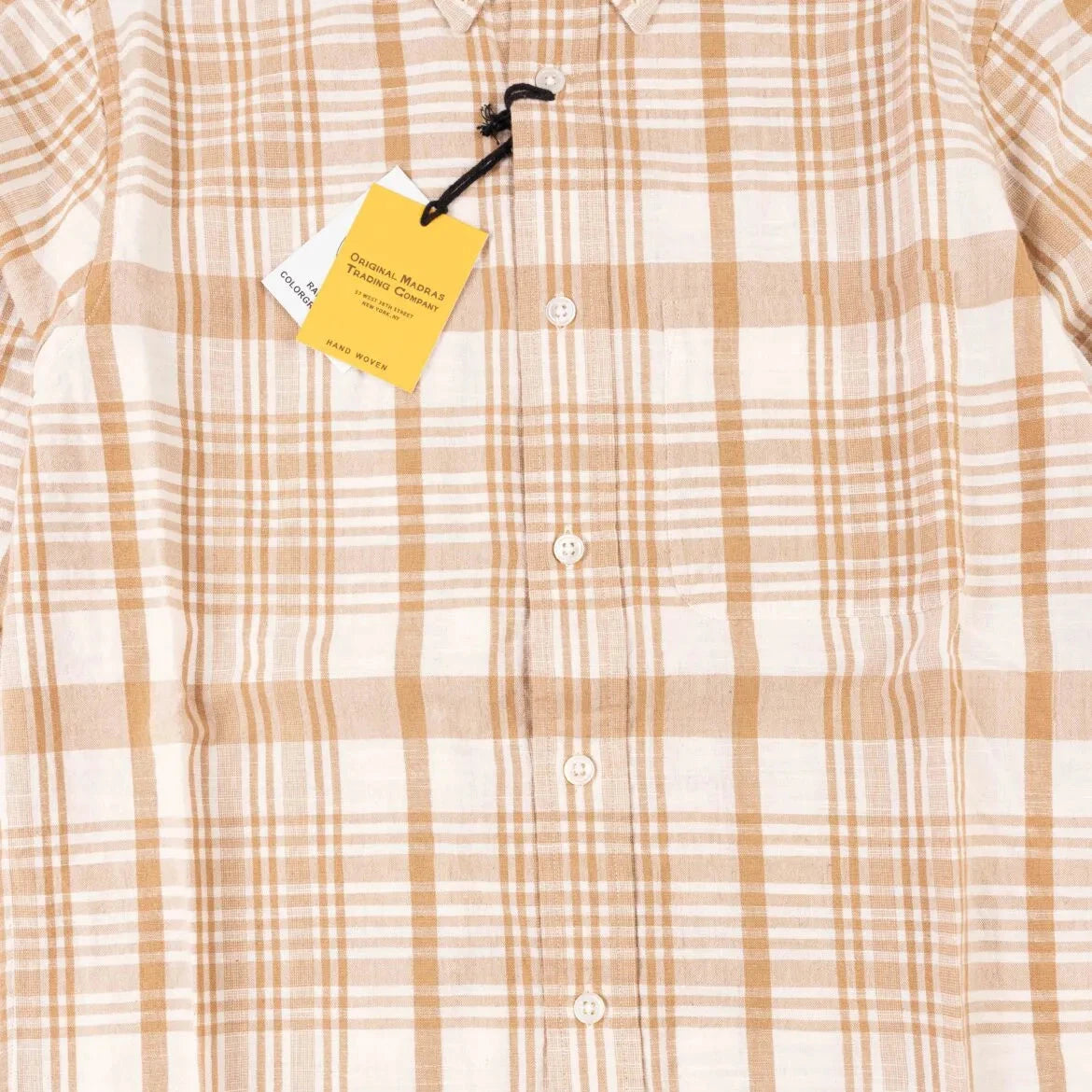 Close-up of the internal label on the Original Madras Trading Company N5 Shirt Beige showing branding and handwoven fabric tag.