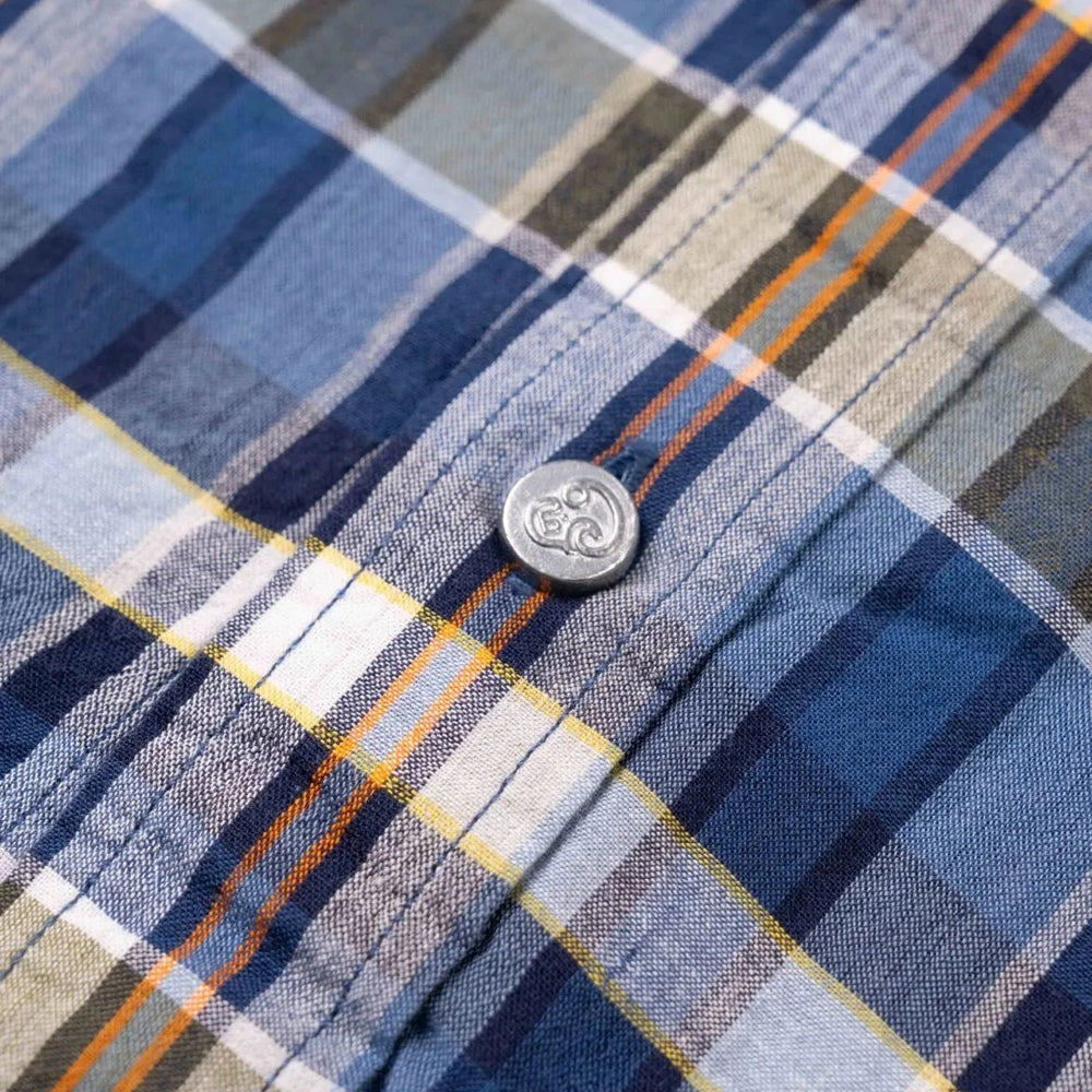 Close-up of the blue–red Madras fabric showing the handwoven texture, color interplay, and lightweight cotton feel.