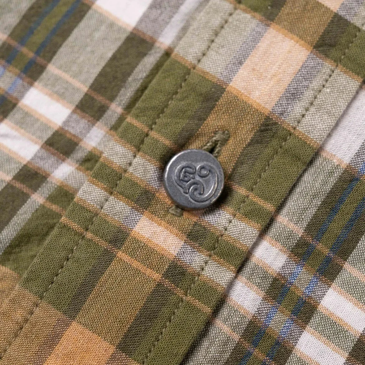 Close-up of the green–yellow Madras fabric showing handwoven texture, color variation, and lightweight cotton feel.