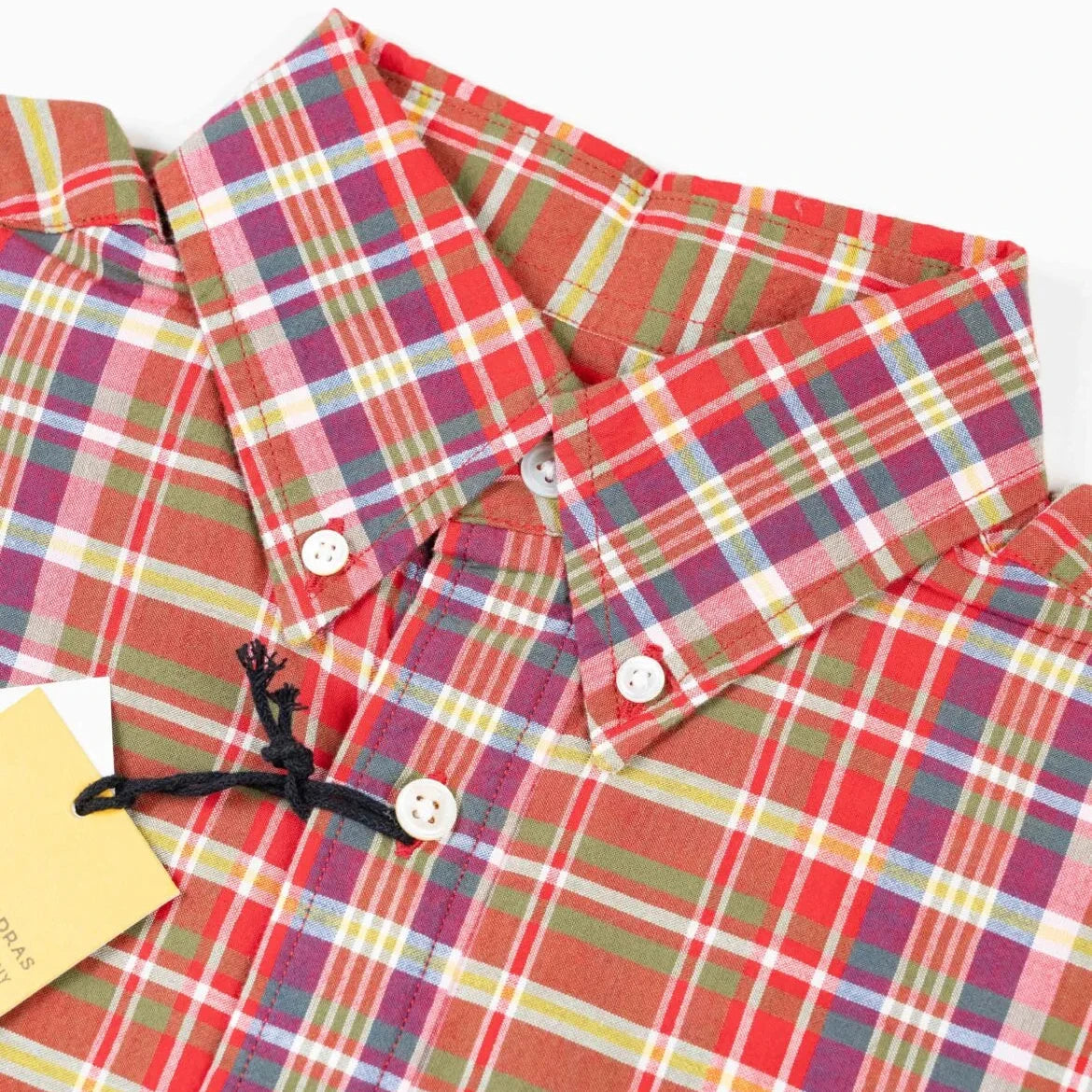 Close-up of the button-down collar on the Original Madras N5 Shirt Red showing the collar roll, stitching, and handwoven Madras texture.
