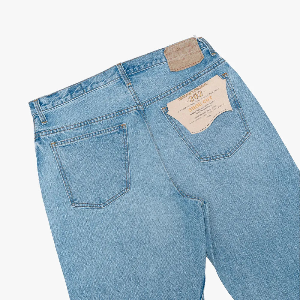 Close-up of the back pocket showing stitching, pocket shape, and worn-in texture.
