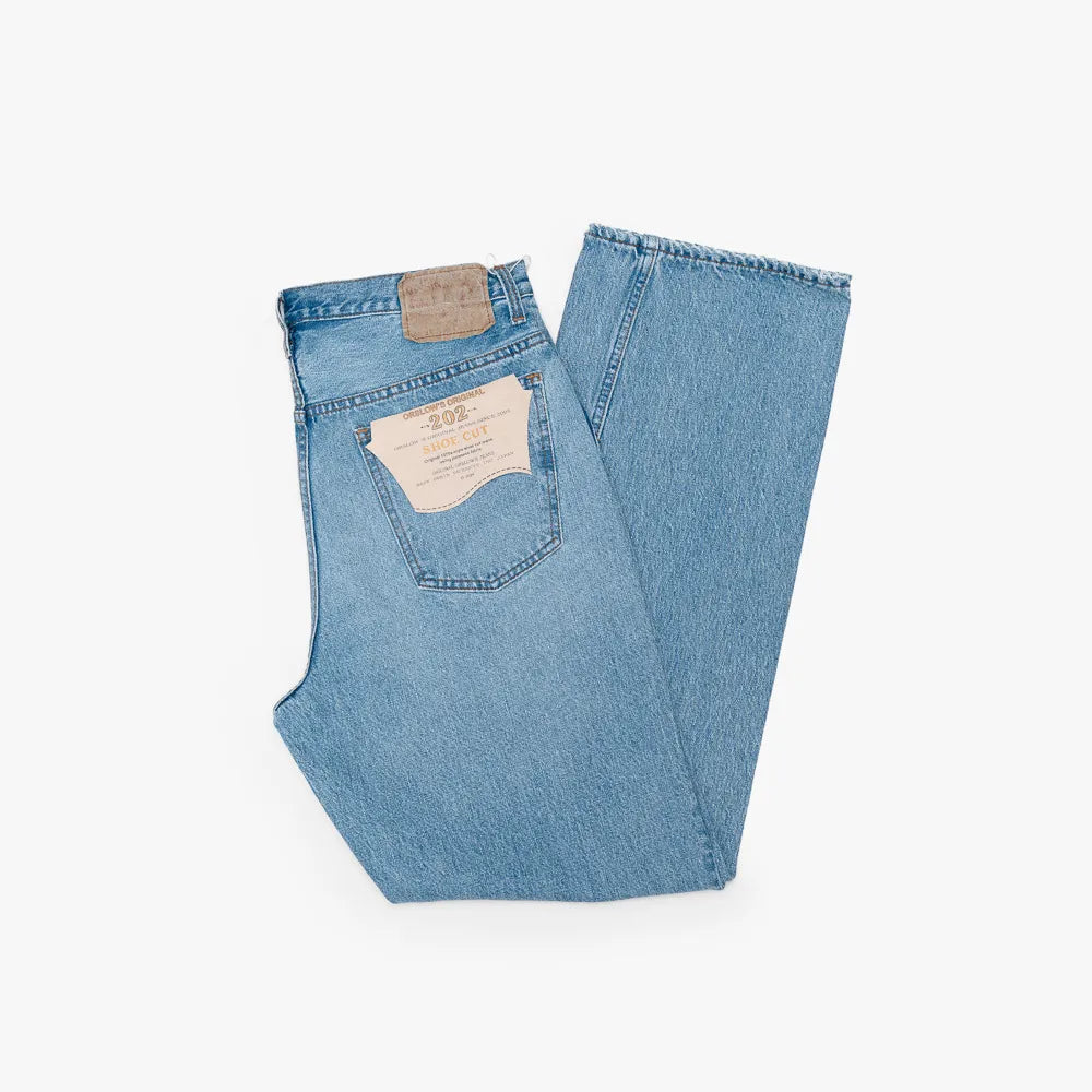 Half-fold view showing denim weight, structure, and drape.