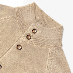 Close-up of the collar closure showing knit texture and refined finishing.
