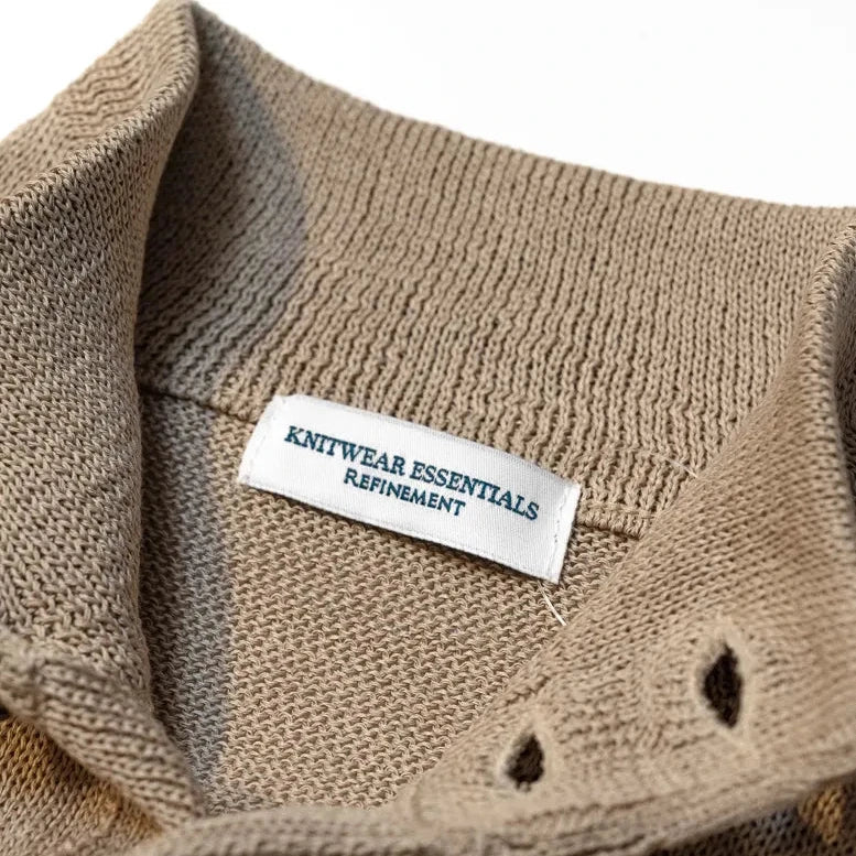 Close-up of the collar and zip closure showing knit texture and refined finishing.
