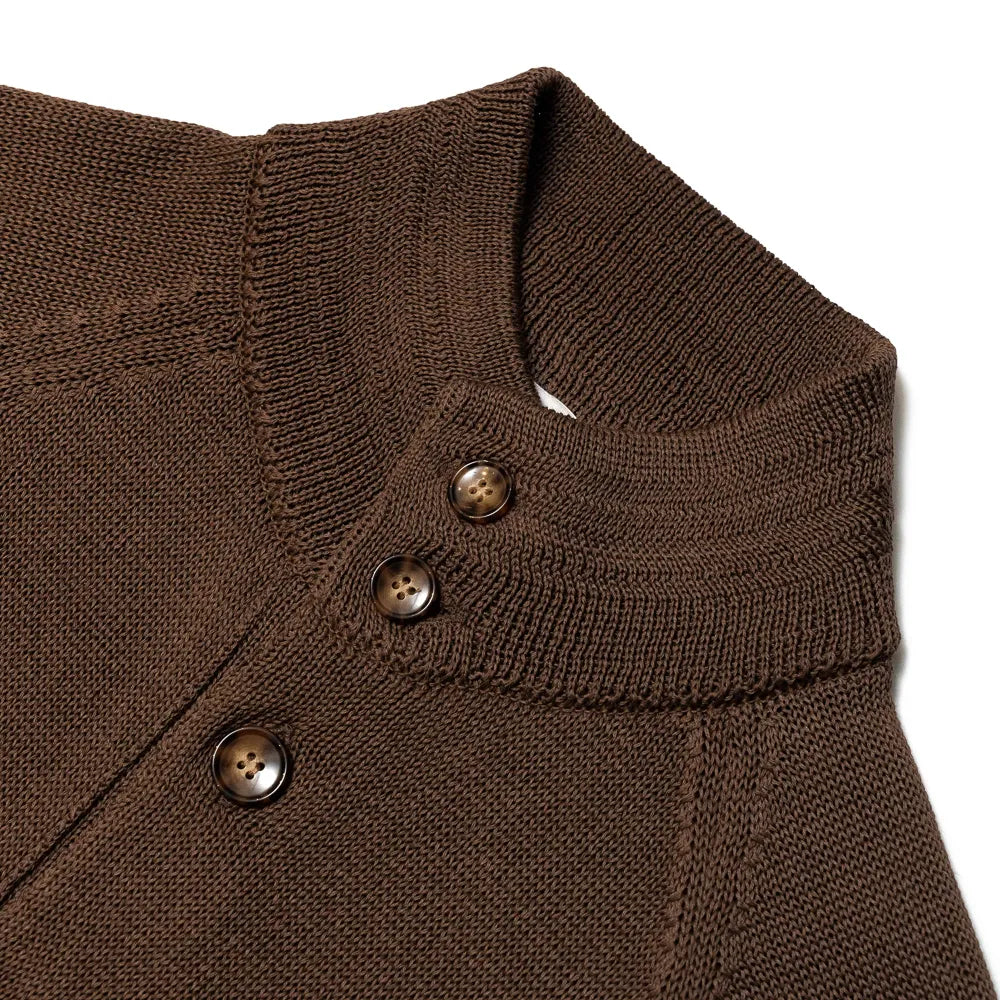 Close-up of the knit bomber collar showing rib-knit structure, button placement, and refined brown yarn texture.
