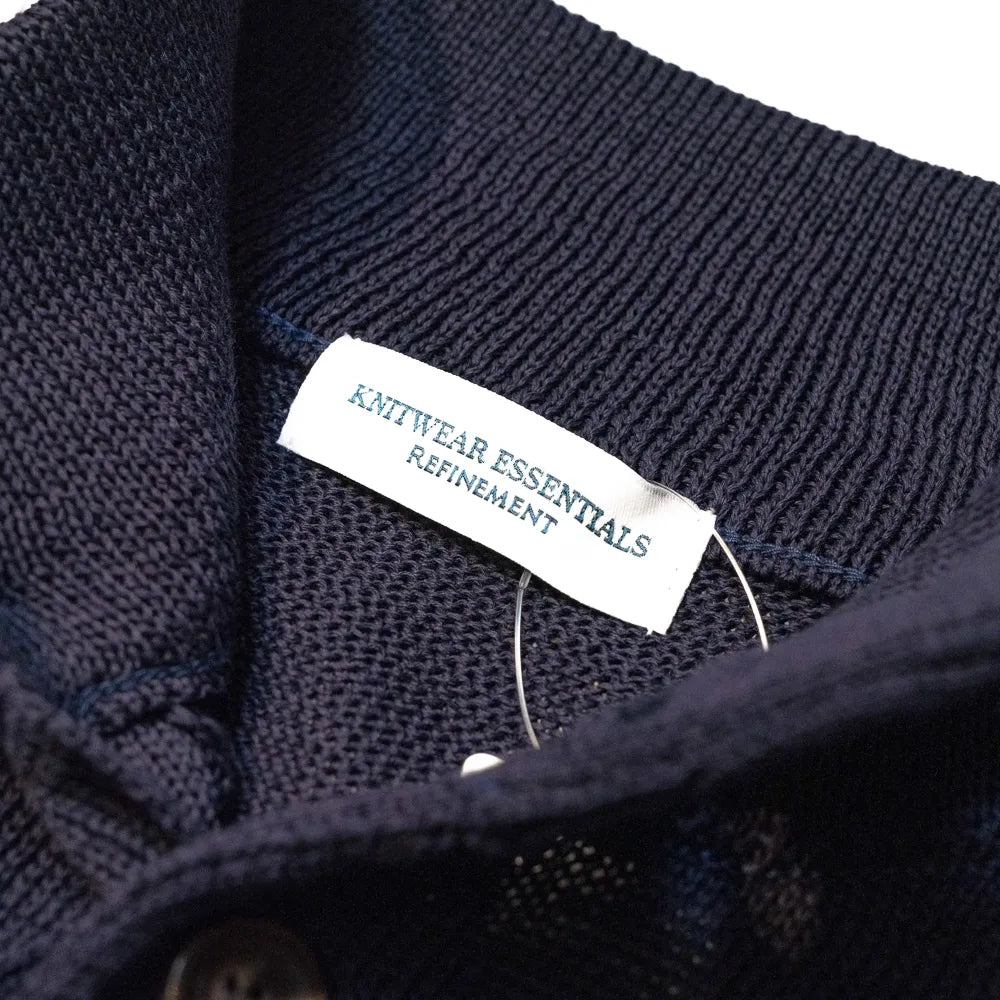 Close-up of the interior label showing “Knitwear Essentials – Refinement” branding and inner knit finishing.