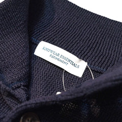 Close-up of the interior label showing “Knitwear Essentials – Refinement” branding and inner knit finishing.