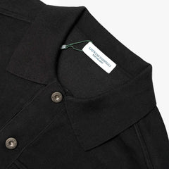 Close-up of the knit collar showing rib-knit construction, stitching precision, and rich black yarn texture.