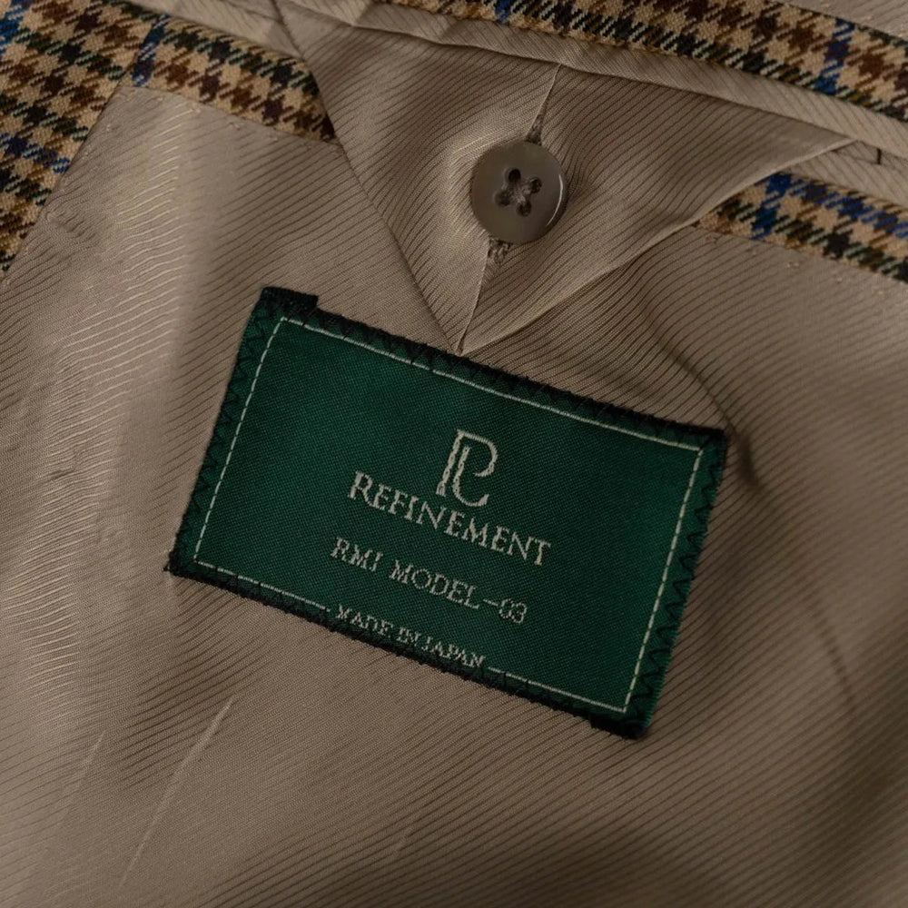 Close-up of the interior label on the RMJ-03 Gunclub Windowpane Jacket showing Refinement Made By Ring Jacket branding and inner lining construction.