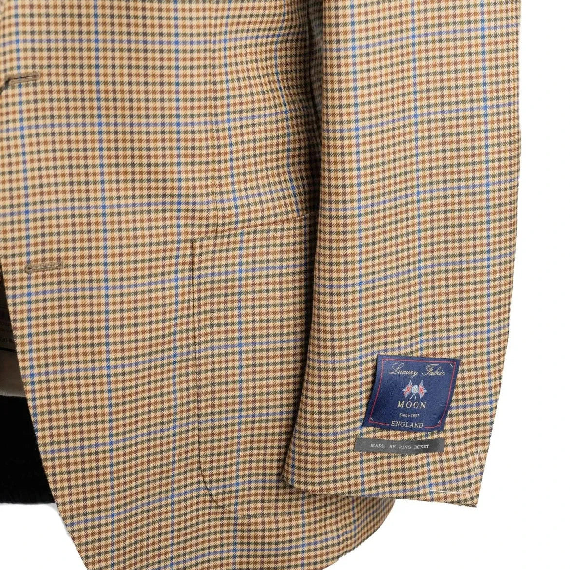 Close-up of the sleeve and hem area of the RMJ-03 Gunclub Windowpane Jacket highlighting sleeve buttons, stitching, and refined tailoring.