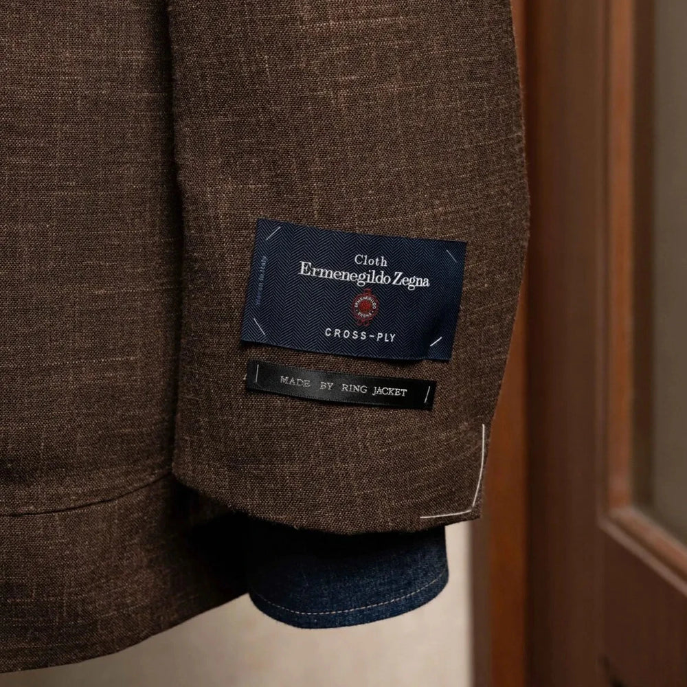 Close-up of the sleeve and hem area of the RMJ-04 Dark Brown Sport Jacket highlighting sleeve buttonwork, stitching, and refined construction.