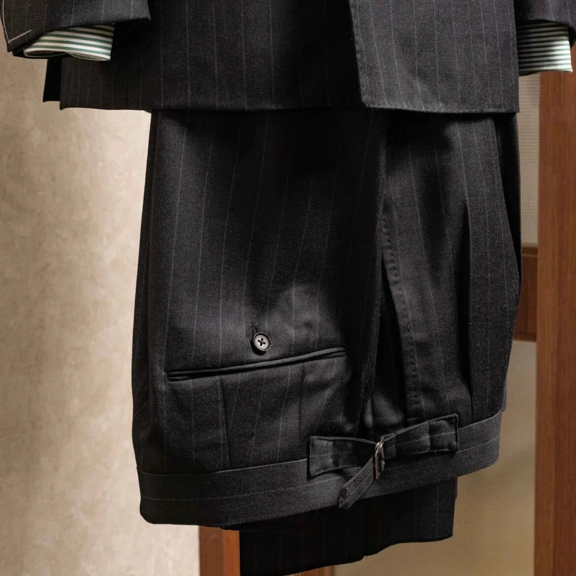 Front view of the trousers from the RMJ-04 Chalk Stripe Charcoal Grey Suit showing pleats, tailored leg shape, and the refined Zegna Electa chalk stripe fabric.