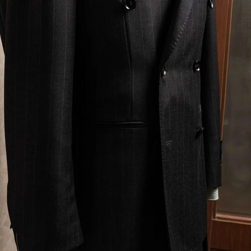 Close-up of the peak lapel on the RMJ-04 Chalk Stripe Charcoal Grey Jacket showing the lapel roll, crisp peak structure, and luxurious Zegna Electa wool texture.
