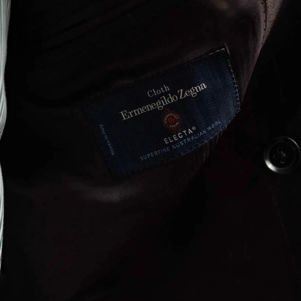 Close-up of the interior labels showing Refinement Made By Ring Jacket branding and the Ermenegildo Zegna Electa fabric label.