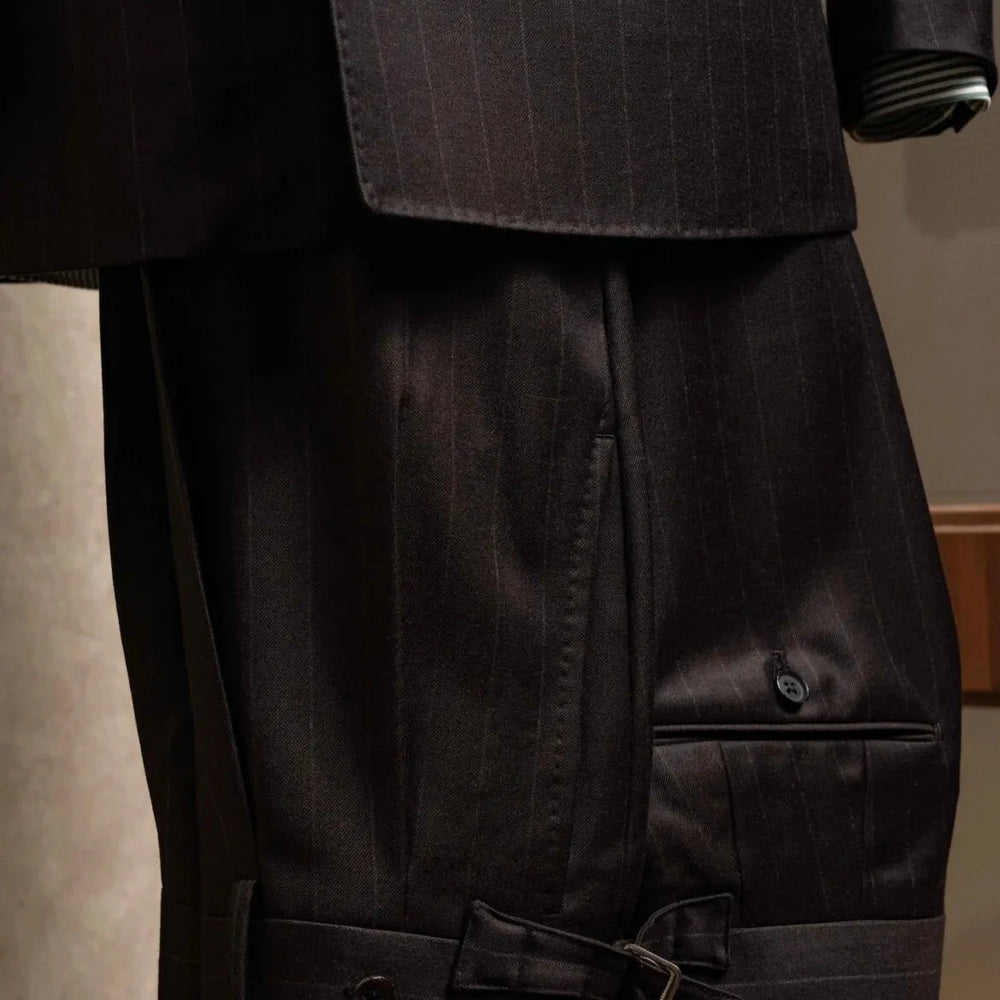 Front view of the trousers from the RMJ-04 Chalk Stripe Dark Brown Suit showing the pleats, clean leg line, and refined dark brown chalk stripe.